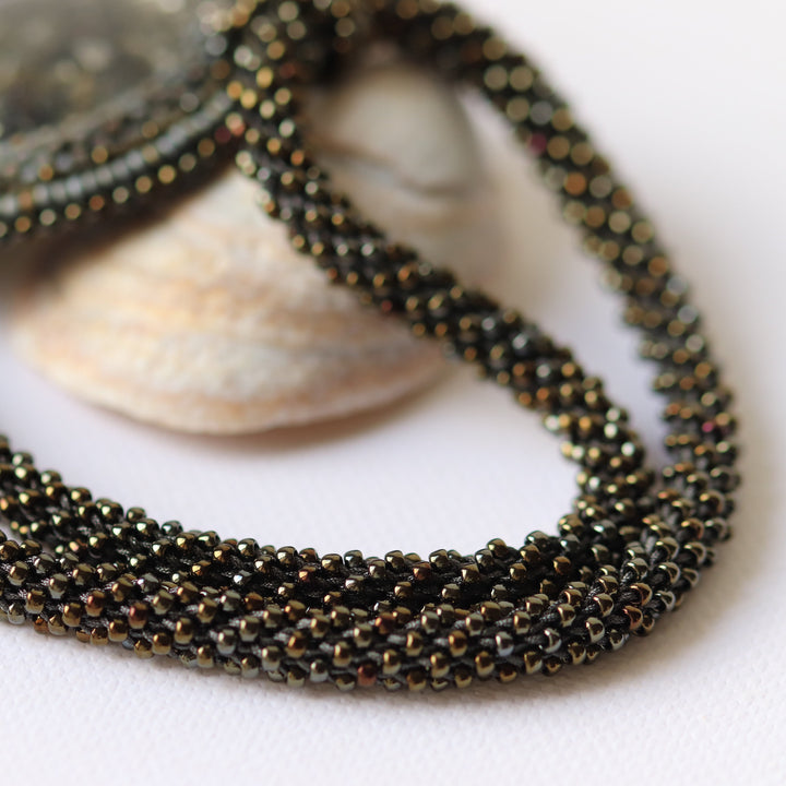 Embroidered necklace with micaschist (mica and garnet)