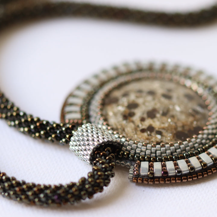 Embroidered necklace with micaschist (mica and garnet)