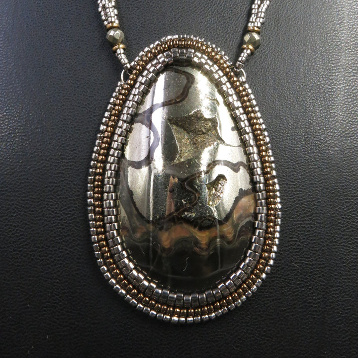 Necklace with pyritized ammonite, yellow calcite