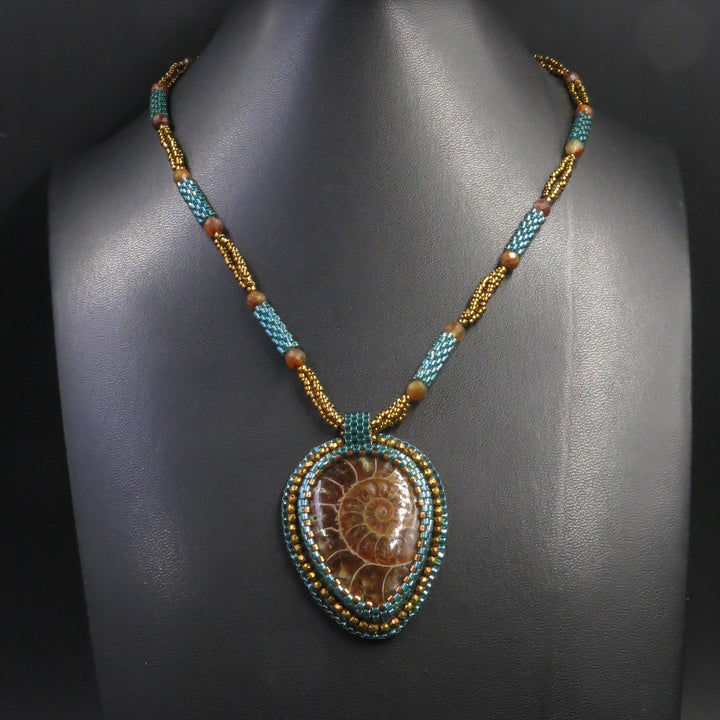 Embroidered necklace with ammonite and pyrite