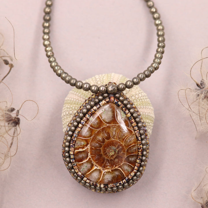 Embroidered necklace with ammonite and pyrite