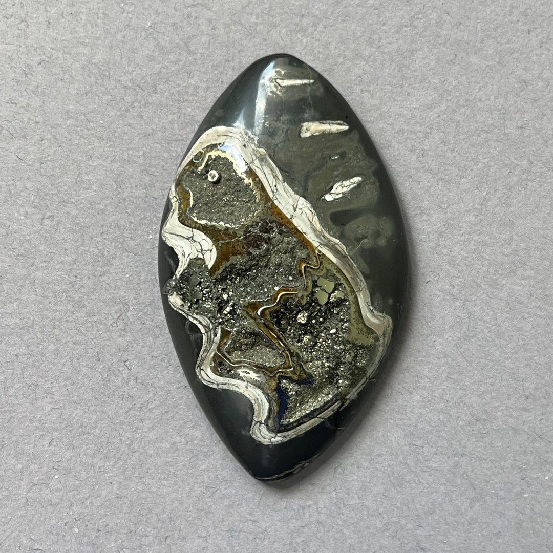 Pyritized ammonite, AM_P302, cabochon cut, 47x28x8 mm