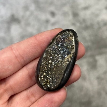 Pyritized ammonite, AM_P071, cabochon cut, 50x25x9 mm; 20g;