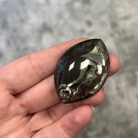 Pyritized ammonite, AM_P075, cabochon cut, 46x33x8 mm; 19g;